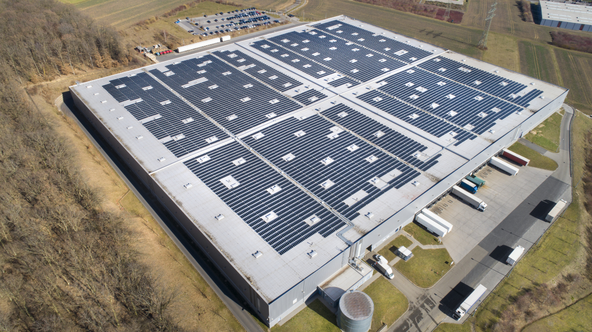 Large industrial building, solar panels and trucks